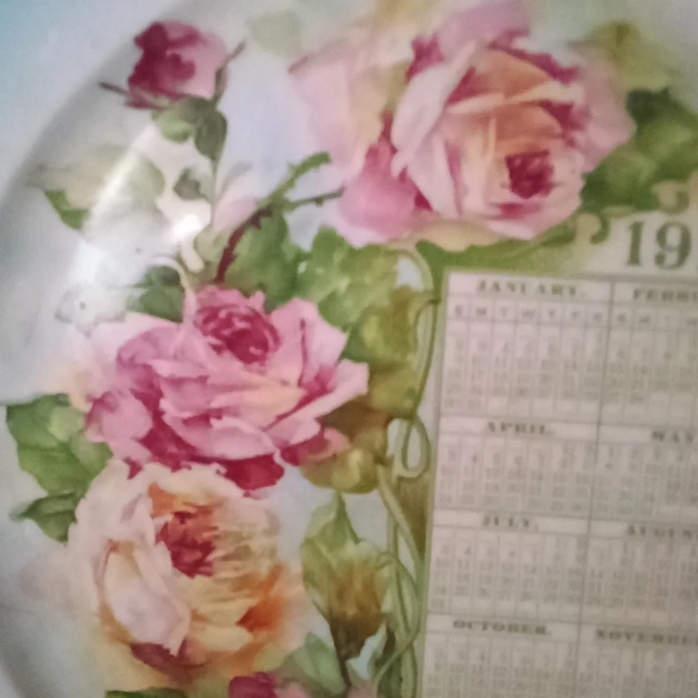 Hand painted calendar advertising plate from 1910. Turquoise & roses
